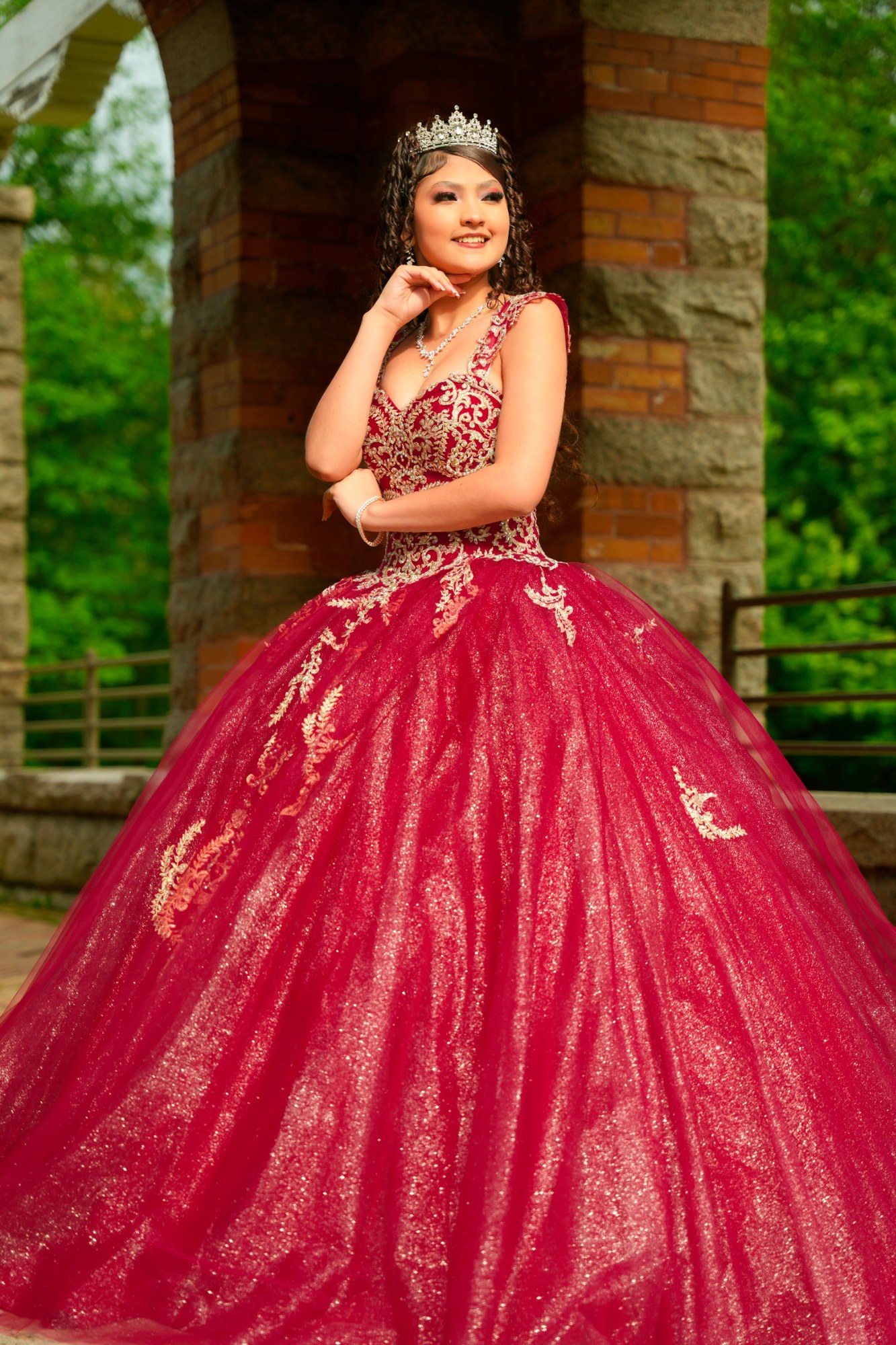 Retrato de quinceañera junto a estructura de piedra